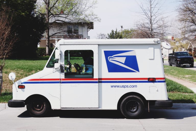 UPSP truck in front of a house